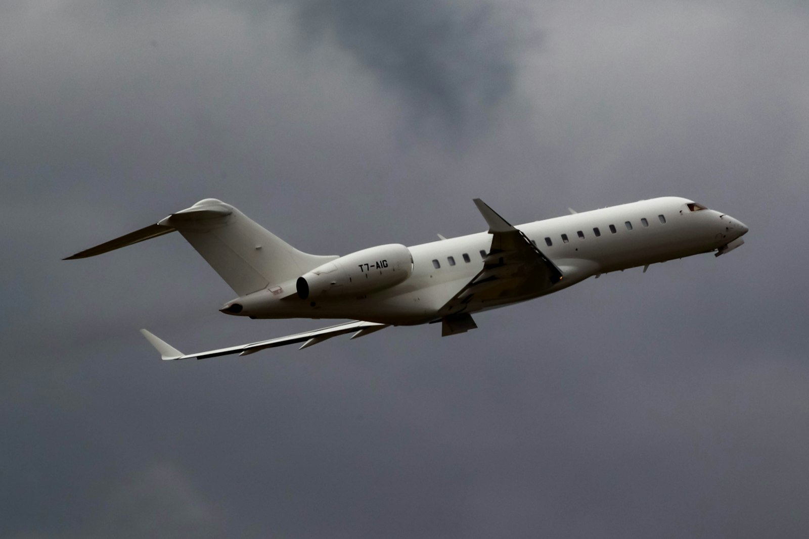 Large-cabin business jet in flight — illustrative stock photo